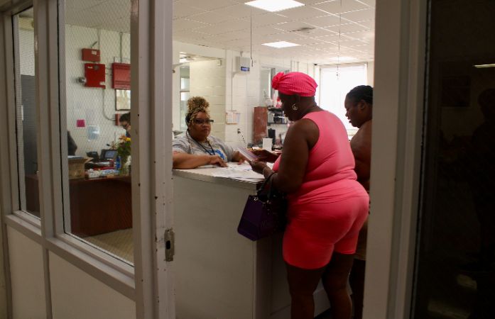  3 people standing at counter completing enrollment packet